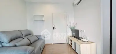 Modern living room with sleek furniture and air conditioning, perfect for comfortable living.