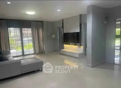 Spacious modern living room with sleek design and large windows for natural light.