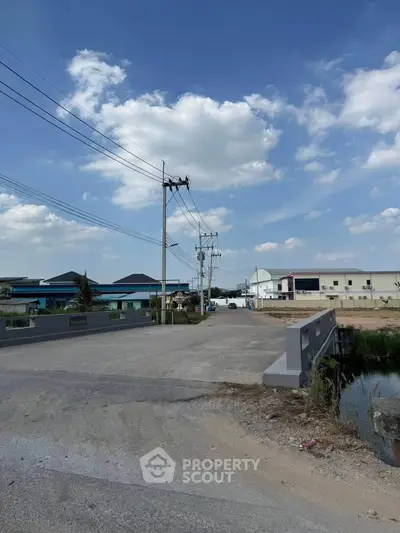 Expansive industrial area with clear blue skies and modern infrastructure, ideal for commercial development.