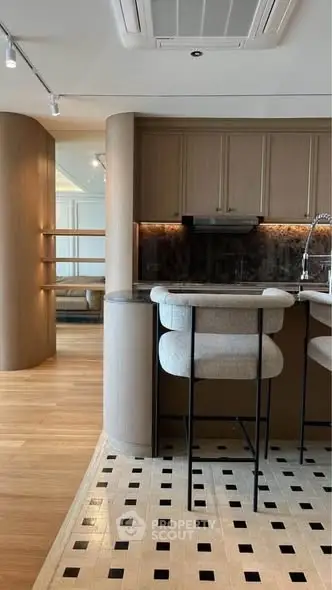 Modern kitchen with stylish bar stools and elegant wooden cabinetry