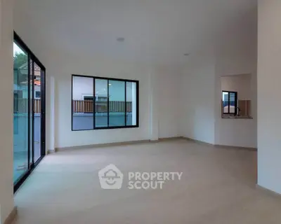 Spacious empty living room with large windows and modern design, perfect for customization.