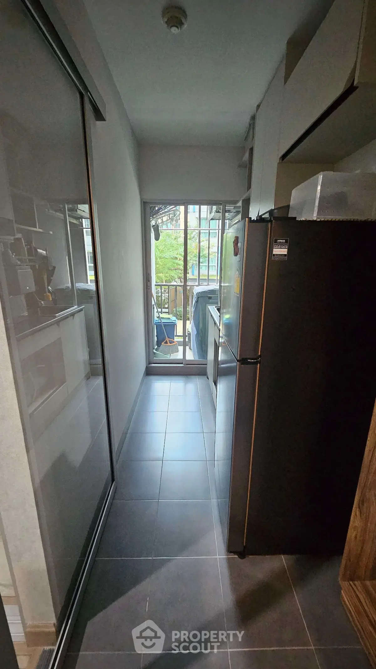 Modern kitchen with sleek appliances and balcony view, perfect for urban living.