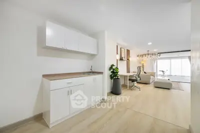 Spacious open-plan living room with modern kitchen and elegant decor