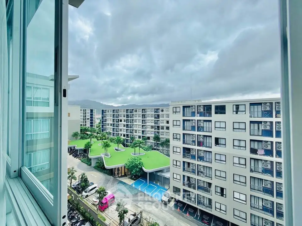 Modern apartment complex with lush green rooftop garden and scenic view