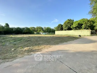 Spacious vacant land with lush greenery, perfect for development opportunities.