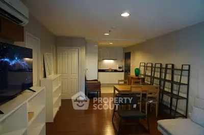 Spacious living room with modern furniture and open kitchen layout