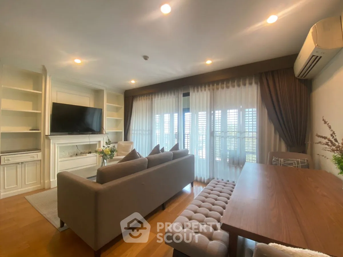 Elegant living room with modern decor and large windows for natural light.