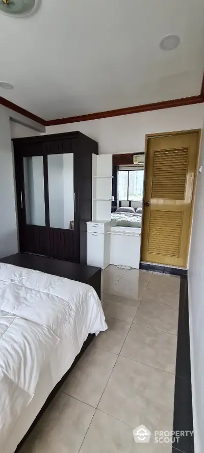 Spacious bedroom with modern wardrobe and natural light