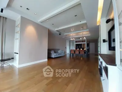 Spacious modern living room with elegant wooden flooring and stylish dining area.