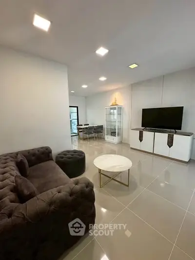 Modern living room with elegant furniture and sleek design, featuring a plush sofa and stylish coffee table.