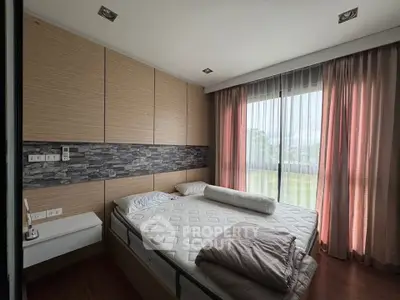 Modern bedroom with large windows and stylish decor
