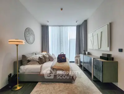 Luxurious modern bedroom with stylish decor and large window for natural light.