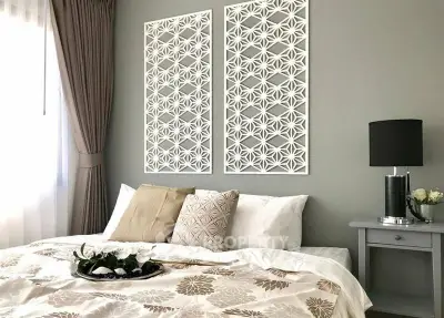 Elegant bedroom with stylish decor and natural light, featuring a cozy bed and modern accents.