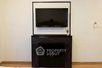 Modern living room with sleek black TV stand and mounted flat-screen TV