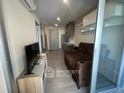 Modern living room with cozy brown sofa and sleek TV setup in stylish apartment.