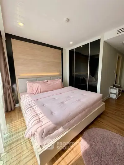 Modern bedroom with stylish decor and ample natural light, featuring a cozy bed and sleek wardrobe.