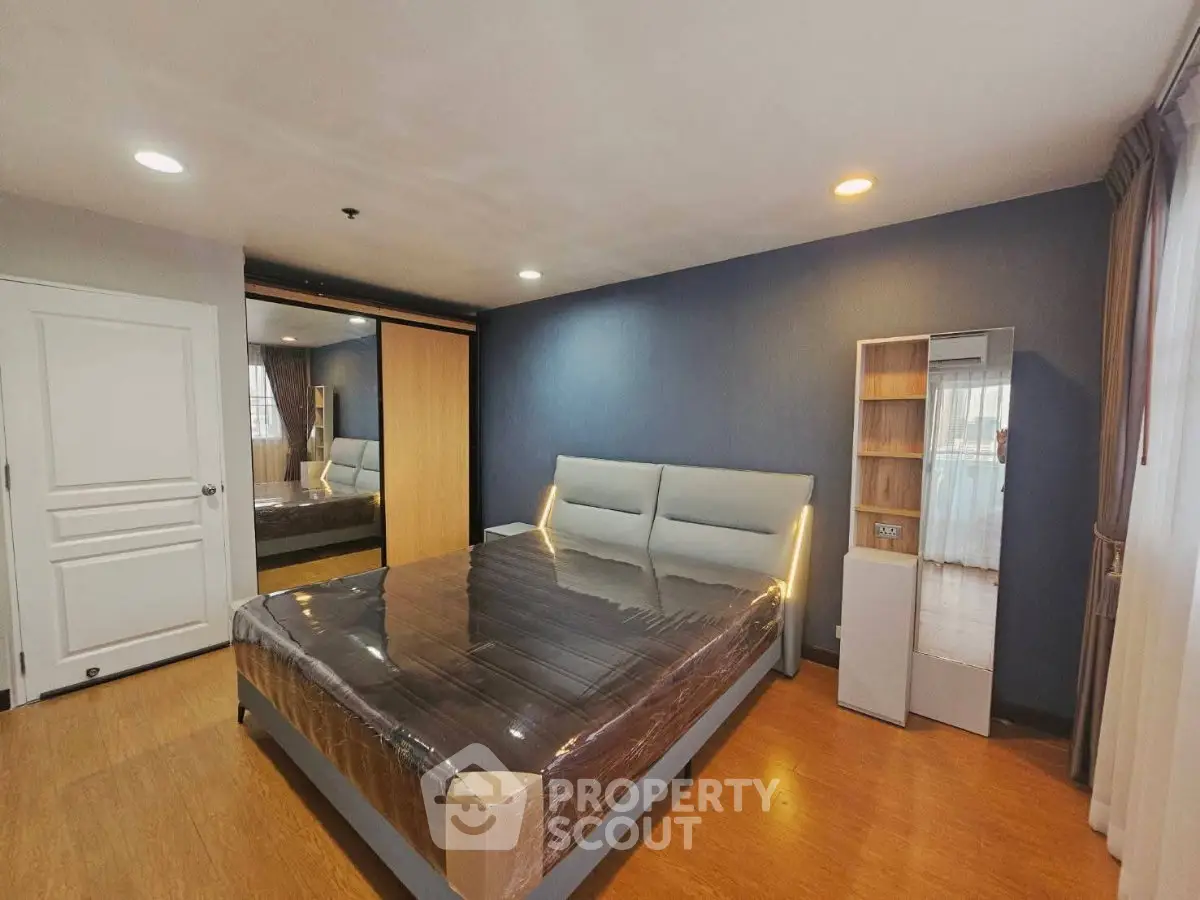 Spacious modern bedroom with sleek design and ample natural light