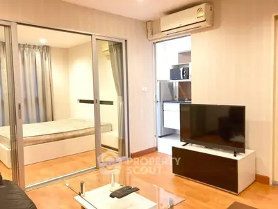 Modern apartment interior with cozy living room and bedroom, featuring sleek furniture and open layout.