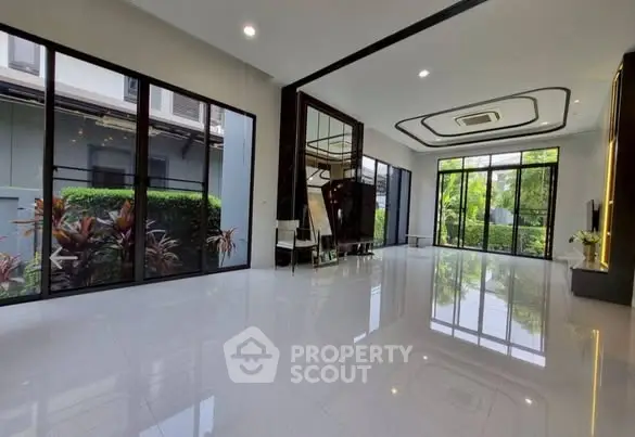 Spacious modern living room with large windows and garden view