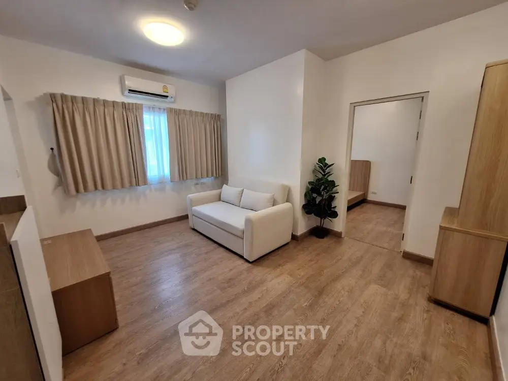 Spacious living room with modern decor and wooden flooring