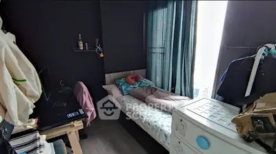 Cozy bedroom with modern decor and natural light, perfect for relaxation and comfort.