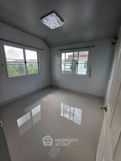 Spacious empty room with large windows and glossy tiled floor, perfect for customization.