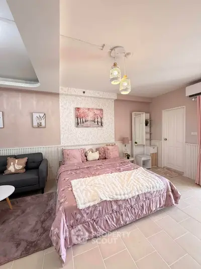 Charming bedroom with elegant decor and cozy ambiance, featuring a plush bed and stylish lighting.