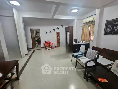 Spacious living room with traditional decor and ample natural light.
