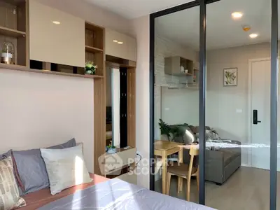Modern bedroom with glass partition and cozy living area