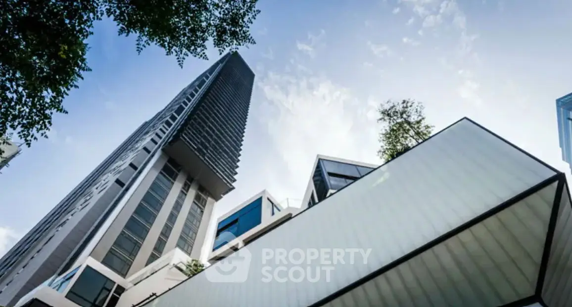 Modern architectural building with sleek lines and glass facade under a clear blue sky.