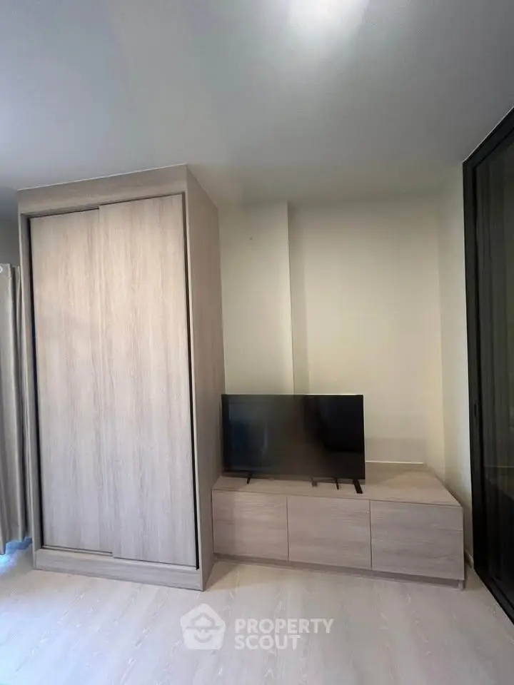 Modern living room with sleek TV stand and built-in wardrobe, perfect for stylish urban living.