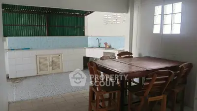 Charming rustic kitchen with wooden dining set and open layout, perfect for cozy family gatherings.