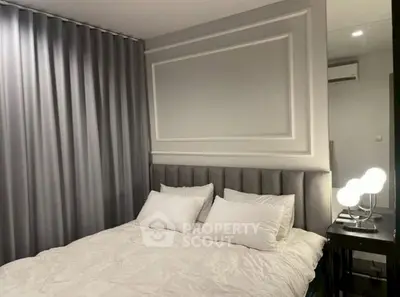 Modern bedroom with elegant decor and soft lighting, featuring a plush bed and stylish curtains.