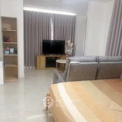 Modern studio apartment with cozy living area and stylish furnishings.