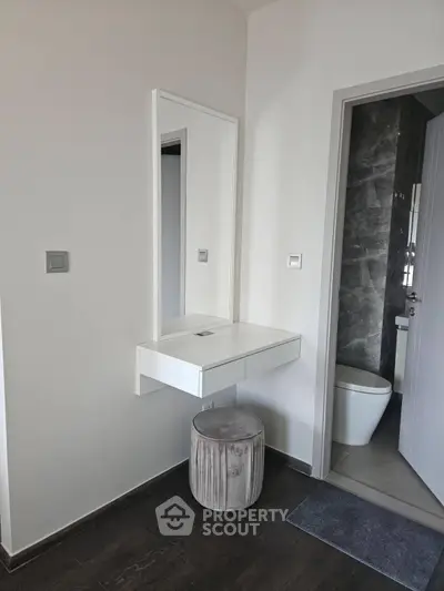 Modern minimalist bathroom with sleek vanity and stool