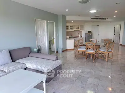 Spacious open-plan living room with dining area and modern kitchen in a stylish apartment.
