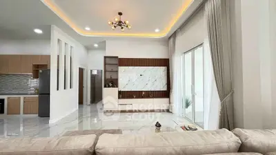 Spacious modern living room with elegant lighting and open kitchen layout