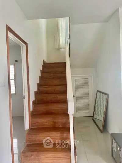 Charming interior staircase with wooden steps and modern design, perfect for contemporary homes.