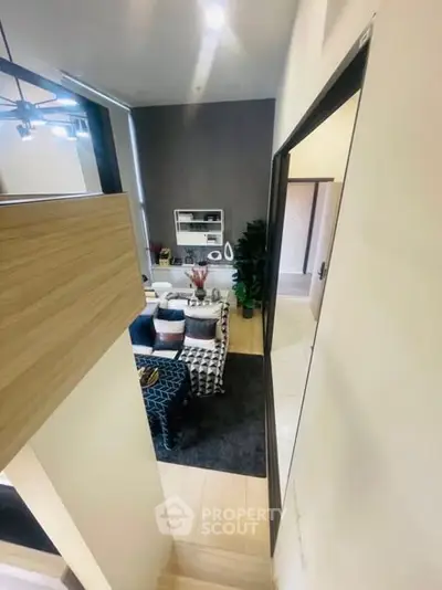 Modern living room with stylish decor and open layout, featuring a cozy seating area and contemporary lighting.