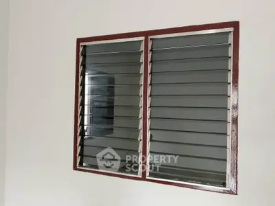 Modern window with horizontal slats in a minimalist interior setting.