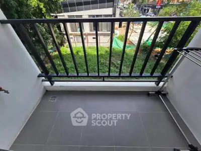 Charming balcony with modern railing and lush green view, perfect for relaxation and enjoying the outdoors.