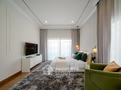 Luxurious bedroom with modern decor, plush rug, and large windows for natural light.