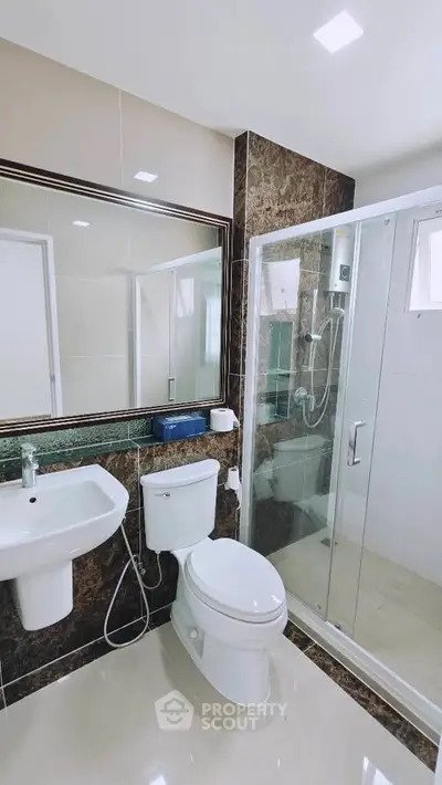 Modern bathroom with glass shower and sleek fixtures