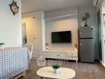 Modern living room with stylish decor and sleek appliances in a cozy apartment setting.