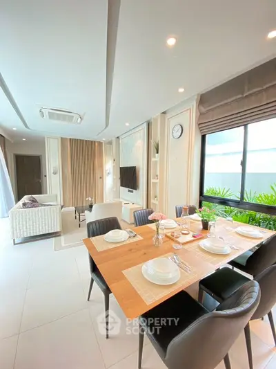 Modern open-plan living and dining area with elegant decor and natural light