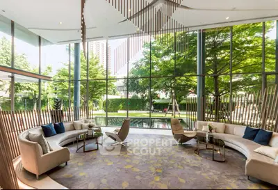Luxurious modern living room with floor-to-ceiling windows and garden view, featuring elegant furniture and decor.