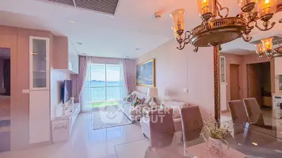 Luxurious living room with stunning ocean view, elegant chandelier, and modern decor in a high-end apartment.