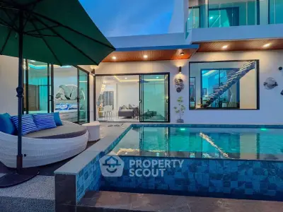Luxurious modern home with private pool and stylish outdoor seating area at dusk.