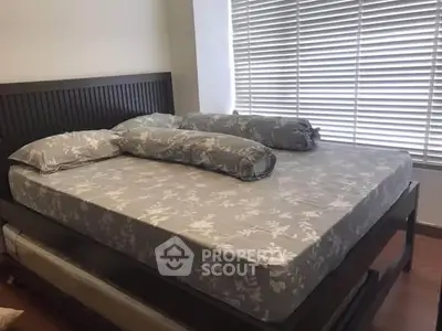 Spacious bedroom with elegant bed and large window blinds