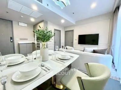Modern open-plan living and dining area with elegant decor and natural light.